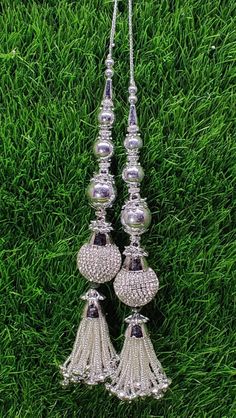 Indian Handmade Silver Latkan for Saree Blouse Lehenga HandBags Hangings Dupatta Decoration Bridal Wedding dress for Women pair of 2 pcs Size - 20.00 cm Length  Item Description You can use this Beautiful pair of tassle for several DIY projects.  *These beautiful Tassel Latkans are used as the accessory for saree blouse on the back, but u can use according to your need and your innovative ideas. * Package contains 2 Latkan / 1 Pair Other Than Saree Blouse, you can use these latkans in various ways Craft Projects Designing Home Decoration Festive celebrations. Evening and party Apparels. Home décor items Apparel & Fashion Scarves n Stoles Headband, hats Table cover, curtains, Pillow covers, Cushion cover Shoe designing Headband, hats Table cover, curtains Designing stylish blouses Ship From Mirror Latkans For Lehenga, Silver Festive Lehenga For Festivals, Silver Lehenga For Festive Occasions, Silver Sets With Mirror Work For Celebration, Traditional Silver Choli With Pallu, Silver Lehenga For Diwali Celebration, Silver Bollywood Lehenga For Celebration, Festive Silver Sets For Celebration, Festive Silver Celebration Sets