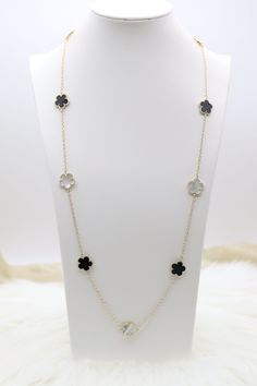 The Mother of Pearl and Black Five Leaf Flower Petal Pendant Necklace displays a radiant pendant crafted with five mother of pearl and black inlaid petals, forming an elegant flower design. This necklace, set on a simple chain, offers a touch of refined beauty that perfectly complements both everyday and formal attire. Length: 36 inches Clover: 14.9 mm Closure: Lobster Claw Material: Brass with 18K Gold Plating and Rhodium Coating Lead Free and Hypoallergenic Elegant Mother Of Pearl Jewelry With Flower Charm, Elegant Black Flower Pendant Necklace, Elegant Black Flower Necklaces, Elegant Flower-shaped Mother Of Pearl Necklace, Black Flower Pendant Necklace With Charm, Elegant Black Necklace With Flower Charm, Black Flower Necklace For Gift, Black Jewelry With Flower Charm Pendant, Black Flower Charm Pendant Jewelry