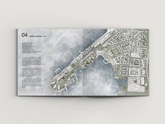 an open book showing the layout of a city with lots of buildings and streets in it