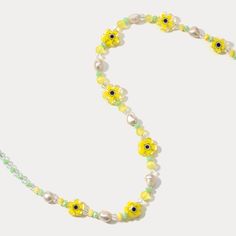 Sunshine around your neck! This delightful Pearl Yellow Flower Beaded Necklace features 18k gold-plated brass and blooms with sparkling crystals and soft yellow pearls. For the nature lover, this color stone necklace captures the beauty of a blooming garden in wearable form, serving as a constant reminder of the wonder and joy found in the natural world. The delicate pearls, sunny gemstones, and pops of vivid color stones come together to create a piece that is both visually stunning and deeply symbolic. DETAILS Plating: 18K Gold Materials: 18K Gold on Brass, Pearl, Natural Stone, Quartz, Crystal Measurements: Length: 16.14"(41cm) + Extender: 2.36"(6cm) Bead Size: 0.39"* 0.51 "(1.0cm*1.3cm) Weight: 19.1 g Summer Gold Jewelry With Flower Decoration, Handmade Yellow Pearl Necklaces, Yellow Pearl Beaded Necklaces As Gift, Spring Jewelry With Colorful Beads In Gold, Spring Gold Jewelry With Colorful Beads, Gold Flower Necklace With Beaded Chain, Gold Flower Shaped Necklace With Beaded Chain, Spring Adjustable Gold Flower Necklace, Adjustable Gold Flower Necklace For Spring