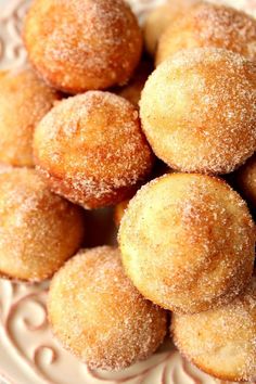 some sugared pastries are on a white plate