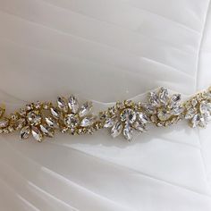 Please choose your ribbon color from the drop down menu. Add glamour to your wedding dress with this gold rhinestone heirloom bridal sash belt. The sash is embellished with high quality glass crystals. The satin sash ribbon is approximately 3.5 yards long. The ribbon is available in many other colors. Measurements: Ribbon is available in two different widths: 5/8 inch 1.5 inches Embellishment is approximately 1.5 inches wide and available in different lengths. Processing: Please allow 2 business Crystal Embellished Bridal Belt, Bedazzled Crystal Bridal Belt For Wedding, Crystal Bedazzled Bridal Belt For Wedding, Crystal Bridal Belt With Rhinestones For Wedding, White Bling Bridal Belt For Wedding, Gold Crystal Bridal Belt For Wedding, Dress Sash Belt, Wedding Bridal Dress, Bridal Sash Belt