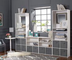 a white bookcase with gray drawers and shelves on the wall next to a window that says, buy one get one 50 % off all system build cube storage