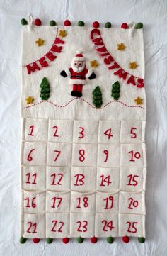 a calendar with santa clause on it and christmas decorations around the numbers in red, white and green