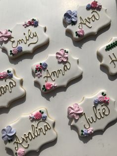 decorated cookies with names and bows are on the table for someone's special occasion