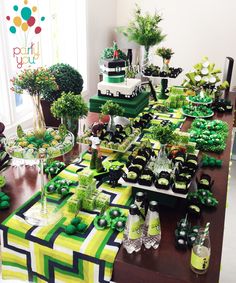 a table filled with green and black desserts