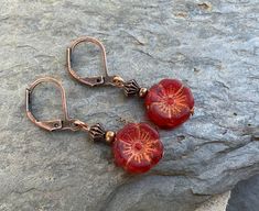 Cute copper earrings with small red and gold hibiscus flower beads. Vintage Red Copper Earrings, Red Copper Earrings, Nickel-free Red Copper Earrings, Red Copper Dangle Earrings, Red Copper Drop Earrings, Red Copper Earrings Gift, Red Copper Earrings As Gift, Back Drop, Flower Beads