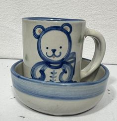 a blue and white cup with a bear on it