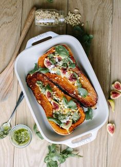 two grilled salmons in a white casserole dish on a wooden table