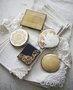 a table topped with lots of different items on top of a white cloth covered table