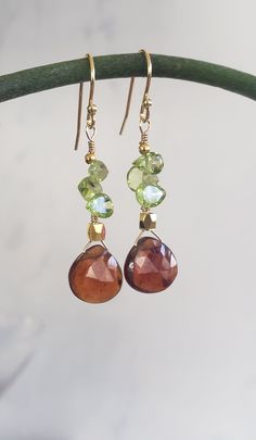 These are very adorable and easy to match any designs high quality Hessonite Garnet Heart beads Dangle Earrings (stone size is 10 mm) with Natural Peridot Faceted Marquise beads (5-8 mm) and delicate 24K Gold Plated solid 925 sterling silver earring hooks. Very elegant earrings!  These earrings are 3.2 Centimeters long. Hessonite Garnet Faceted Heart Briolettes: 10-12 mm, India, Grade AAA Peridot Faceted Marquise and Pear Shape beads: 5-6.5 mm to 5-10 mm, China, Grade AA They will be delivered in a cute gift box! ♡  Designed and Made by AnGjewelry! Handmade Briolette Earrings For Anniversary, Handmade Briolette Yellow Gold Earrings, Amber Dangle Earrings With Lever Back Ear Wires, Handmade Yellow Gold Briolette Earrings, Long Drop French Hook Earrings For Gift, Hypoallergenic Briolette Earrings As A Gift, Hypoallergenic Briolette Earrings For Gift, Unique Briolette Earrings As Gift, Everyday Briolette Gemstone Earrings