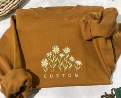 A customizable daisy crew neck sweatshirt, you can destine the color of the shirt, the stamen, the color of the petals (note the thread color number) you can customize the text you want, a unique gift for your loved ones and friends ~. Each sweater is made in the size of your choice, unisex style, unique design ~. Caution. The color of the text and petals are the same, if you have special requirements, please leave me a message~. Due to the nature of the fabric and your monitor or phone screen, Trendy Crew Neck Sweatshirt With Custom Embroidery, Spring Crew Neck Sweatshirt For Gift, Spring Crew Neck Sweatshirt, Customizable Casual Sweatshirt For Gifts, Crew Neck Sweatshirt For Spring, Casual Customizable Sweatshirt For Gift, Fall Custom Embroidery Sweatshirt Gift, Custom Embroidery Sweatshirt As Fall Gift, Trendy Sweatshirt With Letter Embroidery For Spring