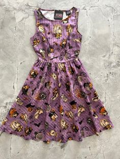 flatlay of purple skull dress 1950s Inspired Dress, Purple Skull, Halloween Clothing, Skirt Pockets, Rockabilly Fashion, Vintage Style Dresses, Halloween Spooky, Skull Print, Halloween Dress