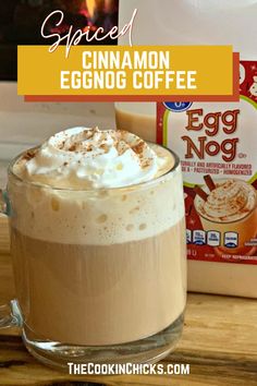 an egg nog drink in a glass mug with whipped cream and cinnamon on top