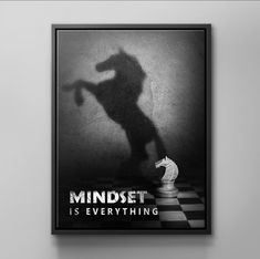 a black and white poster with a shadow of a man holding a chess board in front of him