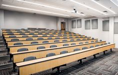 an empty lecture hall with rows of chairs