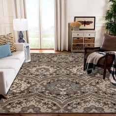 a living room filled with furniture and a large rug