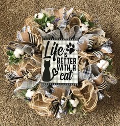 a wreath that says life is better with a cat on it