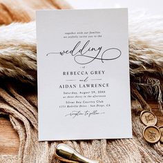 a white wedding card on top of a fur coat next to two gold buttons and a pair of scissors