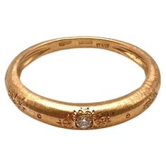 a gold ring with a diamond in the center