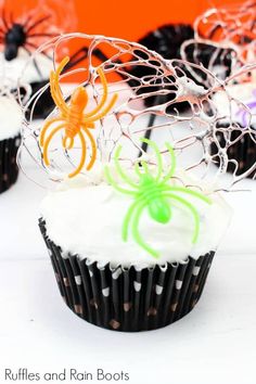 halloween cupcakes with spider web decorations on top