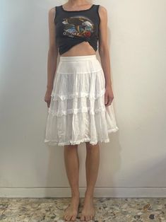 Beautiful 1970s white cotton Kenzo peasant skirt.  The most beautiful part of this skirt is the fine cotton - holds a wonderful shape while being at the same time so light and floaty.  Three tiers of mini ruffles.   Fully lined with more ruffles.  Plastic zipper at the side with one button at the waist.  Label Kenzo Paris, size 40, 100% cotton. Hand wash cool, drip dry. Very good vintage condition with no fabric or sewing flaws.  Measurements Waist 70cm/ 27.5inches Hips - gathers so full Waist to hem 59cm/ 23.5inches Models measurements Shoulders 42cm/ 16.5inches Chest 84cm/ 33inches Waist 66cm/ 26inches Hips 92cm/ 36inches Height 175cm/ 5'9'' Surface Pattern Design Inspiration, Kenzo Paris, Peasant Skirt, Tiered Mini Skirt, Pattern Design Inspiration, Romantic Summer, Drip Dry, Surface Pattern Design, Multi Layering