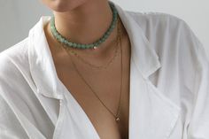 Experience the serene elegance of our Green Aventurine Beaded Necklace. Centered with a dainty Cubic Zirconia charm, this piece encapsulates subtle luxury. The necklace is secured with a gold clasp, offering both sophistication and durability. Customize the length to fit your unique style and make it a versatile addition to your jewelry collection. Whether it's a personal treat or a thoughtful gift, this necklace is an embodiment of grace and craftsmanship. Serene Green Aventurine Dainty Cubic Z Elegant Gemstone Beads Necklaces For Layering, Elegant Faceted Beads Necklace For Layering, Elegant Round Jade Crystal Necklaces, Elegant Beaded Necklaces With Natural Stones For Layering, Elegant Jade Crystal Necklace As Gift, Elegant Jade Crystal Necklace For Gift, Elegant Everyday Beaded Necklaces With Natural Stones, Elegant Beaded Necklace With Natural Stones For Everyday, Elegant Emerald Necklace With Beaded Chain