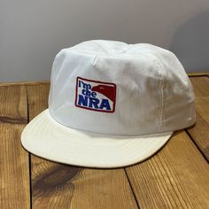 Vintage USA Made I'm The NRA Trucker Hat 1980s 1990s Snapback Cap Circa: 1980's - 1990's Description: "I'm The NRA" Embroidered Trucker Hat. Made in the USA. Size: Snapback - Tagged: One Size Fits ALL - Adult Condition: Shows some light wear. Snapback is in good shape(see pics). Colors are good with some discoloration on the top and bottom of the brim(see pics). Brim is not broken and flat but has some discoloration to the top and bottom(see pics). Sweatband shows light wear and some light disco Vintage Snapback Dad Hat With Embroidered Logo, Vintage White Dad Cap, Retro Dad Hat With Embroidered Logo Snapback, Vintage White Trucker Hat With Embroidered Logo, Retro Dad Hat With Embroidered Logo, Vintage Dad Hat With Embroidered Logo, Retro White Dad Hat, Vintage White Dad Hat, White Vintage Snapback Hat