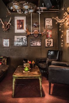 a living room filled with furniture and pictures on the wall