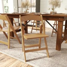 a wooden table with two chairs next to it on top of a carpeted floor