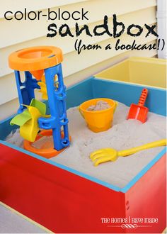 a sandbox with toys in it sitting on the floor