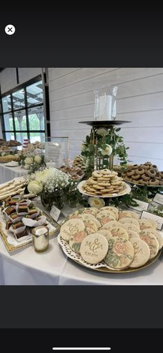 a table topped with lots of cookies and pastries