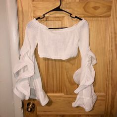 A Cropped White Top With Flowy Long Sleeves, Never Been Worn White Long Sleeve Crop Top With Ruffles, White Ruffled Long Sleeve Crop Top, Long Sleeve Ruffled Crop Top For Day Out, White Crop Top For Beach In Fall, White Crop Top For Beach In Fall Season, Long Sleeve Summer Crop Top For Day Out, Summer Long Sleeve Crop Top For Day Out, White Long Sleeve Crop Top For Vacation, Cropped White Long Sleeve