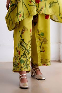 Mustard hand painted kalamkari kaftan with kalamkari tone-on tone embroidered yoke. Comes with creeper pattern kalamkari pant.
Components: 2
Pattern: Hand Painted
Type Of Work: Kalamkari
Neckline: Mandarin
Sleeve Type: Batwing
Fabric: Hand Spun Cotton
Color: Yellow
Other Details: 
Kurta length: 34 inches
Disclaimer: Pure hand painted kalamkari pieces will have irregularities, no pieces will be identical
Occasion: Work - Aza Fashions Creeper Pattern, Archana Jaju, Cotton Painting, Pant Set For Women, Paint Types, Pant Set, Hand Spinning, Bat Wings, Set For Women