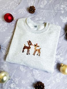 Reindeer Christmas Embroidered Sweatshirt *Christmas embroidered sweatshirt, embroidered crewneck, embroidered sweater, Christmas crewneck, embroidered Christmas, Christmas gift, holly and jolly, merry and bright, the season for giving, spooky season* ABOUT THIS SWEATSHIRT: This crewneck is the perfect solution for what to wear the next time you're feeling the holiday spirit. It's cozy soft and has a unisex fit that can be styled any number of ways. Embroidered with special care, it's sure to last you a lifetime (unless you eat too many candy canes while wearing it). Every sweatshirt is hand made to order and usually takes between 5-7 business days to ship, so please plan in advance if you're looking for something to wear to a holiday party or to give as a gift! This is a unisex crewneck s Christmas Crewneck Sweatshirt Embroidery, Christmas Crew Neck, Christmas Crew Neck Sweatshirt With Embroidered Logo, Holiday Embroidered Crew Neck Sweatshirt, Embroidered Crew Neck Sweatshirt For Holiday, Christmas Crew Neck Sweatshirt With Embroidered Graphics, Christmas Embroidered Crew Neck Sweatshirt, Christmas Embroidery Sweatshirts, Embroidered Christmas Sweatshirt