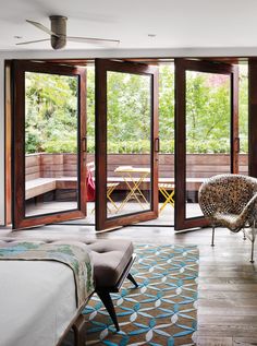 a bedroom with sliding glass doors that open up onto a deck area and outside patio