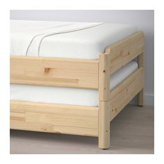 a wooden bed frame with white sheets and pillows