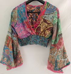 Embrace the beauty of nature with our unique floral handmade top, a masterpiece that will elevate your wardrobe with its charm and sophistication. Crafted with meticulous attention to detail, this enchanting piece seamlessly blends artisanal charm with contemporary patchwork elegance. Affordable Brown Patchwork Tops, Bohemian V-neck Blouse With Multicolor Embroidery, Multicolor Floral Print V-neck Peasant Top, Multicolor V-neck Peasant Top For Festival, Spring Bohemian Patchwork Blouse, Bohemian Spring Blouse With Patchwork, Bohemian Spring Patchwork Blouse, Bohemian Patchwork Blouse For Spring, Cotton Patchwork V-neck Blouse