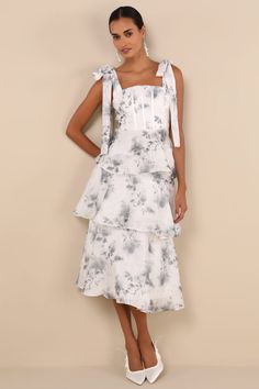 You'll be the most stunning sweetie at any soiree in the Lulus Compellingly Gorgeous Ivory Floral Tiered Tie-Strap Midi Dress! Lightweight woven fabric, with a subtle floral jacquard and a moody grey floral print, shapes wide tying shoulder straps that support a bodice with a square neckline and seamed satin boning. Turn around to reveal a flirty lace-up back that's sure to get you compliments! Fitted waist tops a tiered and ruffled skirt that falls to a midi hem. Hidden zipper/clasp at back. Fi Organza Dresses, Tie Strap Dress, Fall Maxi, Maxi Dresses Fall, Baby Shower Dresses, Shower Dresses, Ruffled Skirt, Floral Jacquard, White Maxi