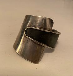 This American Modernist Ed Wiener's sterling silver mid-century cuff bracelet measures 2.25 inches wide. It is in good vintage condition. The black has a little wear and as a result I lowered the price accordingly. I polished the sterling with a cloth to give it a little shine, but it can probably be cleaned more.  It was definitely worn by someone. Modernist Polished Cuff Bracelet, Modernist Cuff Bracelet With Polished Finish, Vintage Cuff Bangle With Polished Finish, Vintage Wide Band Bracelet For Formal Occasions, Modernist Polished Silver Cuff Bracelet, Modernist Bangle Cuff Bracelet For Formal Occasions, Formal Wide Band Sterling Silver Cuff Bracelet, Modernist Polished Cuff Bangle Bracelet, Vintage Sterling Silver Cuff Bangle