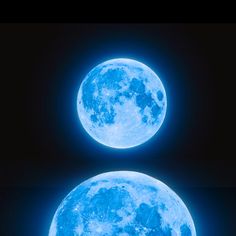 two blue moons are shown in the dark sky