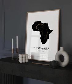 a black and white poster with the word akwaba on it next to candles