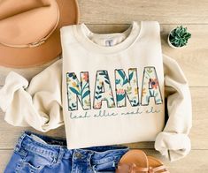 Mother's Day Gift Grandma Gift Personalized Sweatshirt Nana Custom Sweater New Grandma Gifts Baby Announcement Pregnancy Reveal Nana Shirt Whether it's a birthday, Mother's Day, or just a thoughtful surprise, this personalized sweatshirt makes for a heart-touching gift for grandmothers who hold their grandchildren close to their hearts. Personalize this sweatshirt with the names of your grandma's or Nana's pride and joy - her grandchildren!  These make a great gift for new Grandmothers, Nana, and Gigi's! Great for Christmas gifts, Mother's Day gifts, baby shower gifts or baby announcement gifts!  How to Order: -Browse our selections of styles and colors -Reference the sizing chart  -Choose your color/size from the drop down menus -Type your personalization in the box provided - double chec Pumpkin Sweatshirts, Look Retro, Christian Sweatshirt, Cat Hoodie, Add To Cart, 자수 디자인, Pumpkin Design, Halloween Sweatshirt, Embroidered Sweatshirts