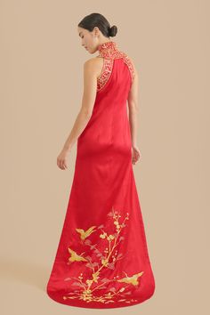 Say hello to your inner warrior princess while wearing this one-of-a-kind, hand embroidered Chinese wedding cheongsam dress. Admire the intricate, yet dramatic high mandarin collar paired with a modern halter top. Zoom in to see the elegant hand-embroidered cranes delicately sewn throughout the body and train of the qipao. If Mulan had a powerful outfit for her Chinese wedding, this would be it. Pair this with our Ruby hairpin to fully unleash all the power and beauty within you. Check out addit Ceremonial Dresses With Floral Embroidery, Ceremonial Fitted Embroidered Dress, Ceremonial Fitted Dress With Floral Embroidery, Ceremonial Fitted Floral Embroidery Dress, Traditional Cheongsam For Ceremony, Wedding Cheongsam With Embroidered Stand Collar, Wedding Cheongsam With Stand Collar And Embroidery, Ceremonial Fitted Embroidered Ao Dai, Fitted Dress With Gold Embroidery For Ceremony