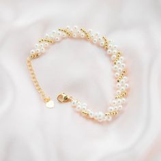 This beautiful bracelet features three layers of delicate baby pearls, delicately strung on a gold plated chain. The bracelet is accented with gold beads, adding a touch of luxury to the piece. The perfect accessory for any occasion, this bracelet will add a touch of elegance to any outfit. The pearls are of highest quality, lustrous and of round shape, perfect for everyday wear or as a special gift. Pearl Type: Freshwater Pearls Pearl Quality: [Shape]: Round [Pearl Size]: 3-4mm [Blemish]: Minim Gold Pearl Charm Chain Bracelet, Pearl Bracelets With Gold Beads As A Gift, Dainty Pearl Beaded Bracelets For Party, Elegant Pearl Bracelet With Tiny Beads, Gold Pearl Bracelet With 14k Gold Filled Pearl Chain, Elegant Tiny Beads Pearl Bracelet, Gold 14k Gold Filled Pearl Chain Bracelet, Gold Pearl Chain Bracelet In 14k Gold Filled, Elegant Pearl Beaded Bracelets With Tiny Beads