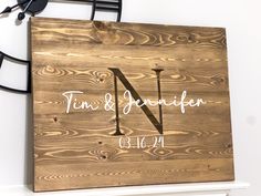 a wooden sign with the letter n on it