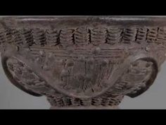 an ancient vase with carvings on the outside and inside, is shown in this image