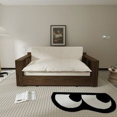 a living room with a white couch and black rug