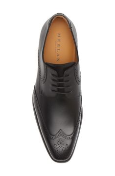 Classic broguing stipples the upper of a burnished-leather derby that adds clean grounding to your sophisticated styles. Lace-up style Cushioned footbed Leather upper and lining/rubber sole Made in Spain Classic Wingtip Lace-up Shoes With Leather Lining, Elegant Moc Toe Dress Shoes With Brogue Detailing, Elegant Lace-up Brogue Shoes With Moc Toe, Elegant Lace-up Shoes With Brogue Detailing And Moc Toe, Business Oxfords With Perforated Plain Toe, Business Oxfords With Perforated Toe Box, Leather Oxfords With Perforated Toe Box For Semi-formal Occasions, Leather Oxfords With Perforated Toe Box For Business, Timeless Formal Lace-up Shoes With Leather Lining