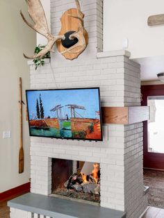 a fireplace with a television mounted on it's side